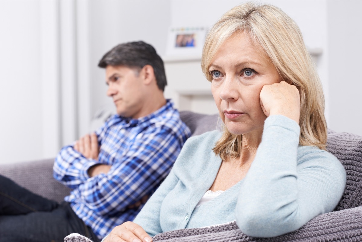 unhappy man and woman sitting on a couch