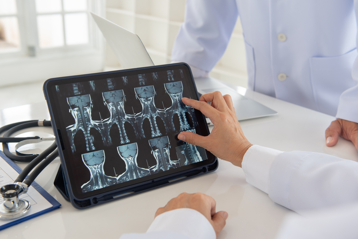 Doctor looking at x-rays of the neck. 