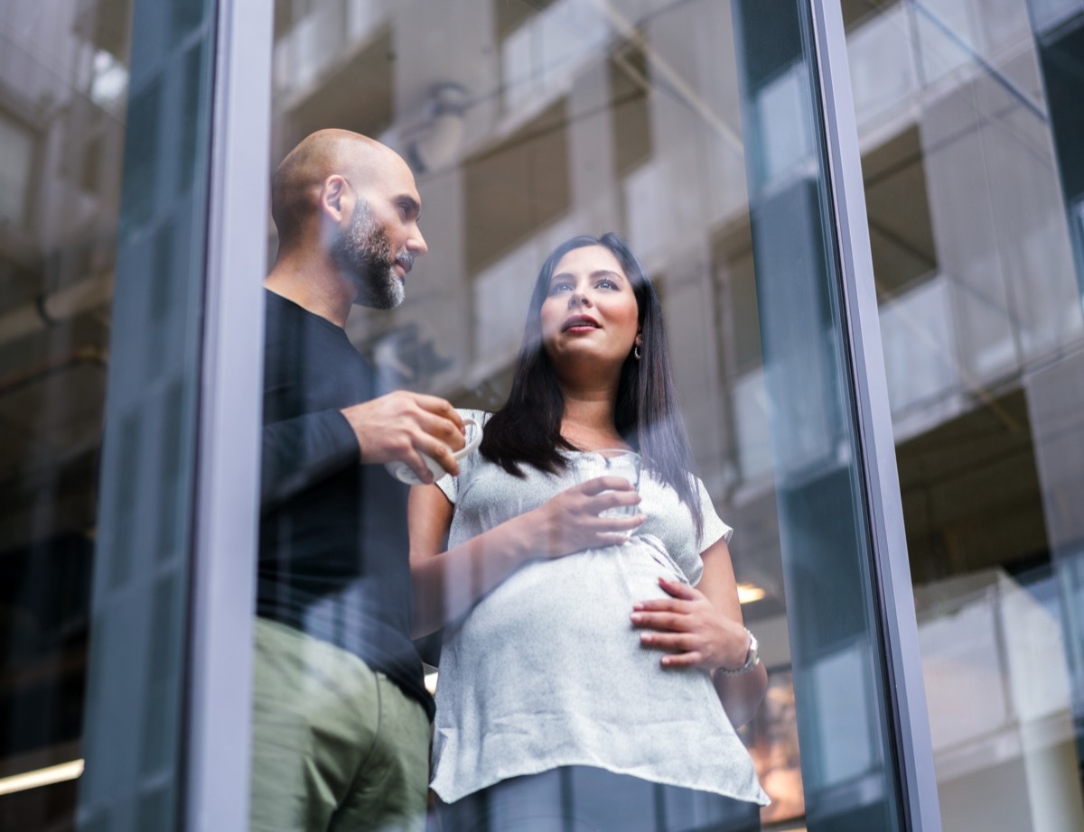 man talking to pregnant woman