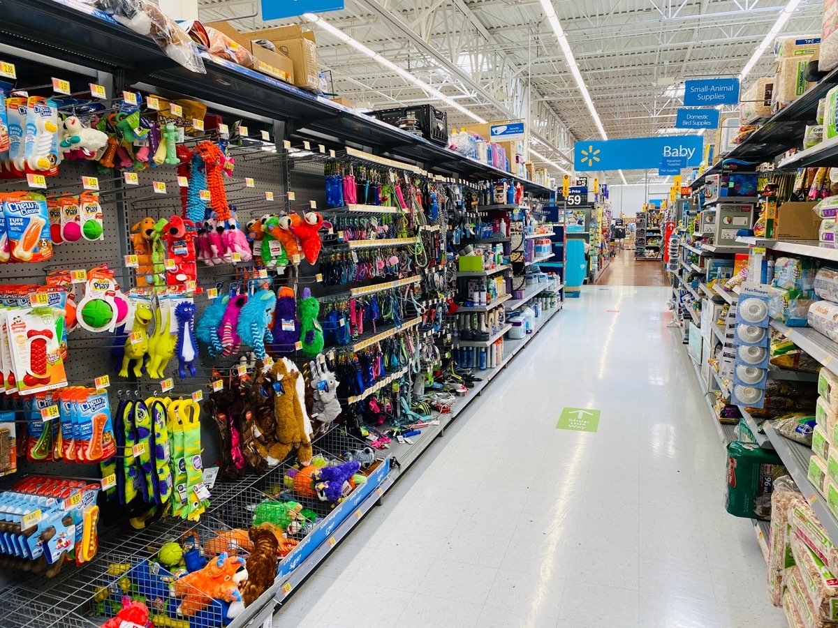 View of a pet section isle at Walmart supercenter with toys, leashes and other supplies for dog owners￼￼.