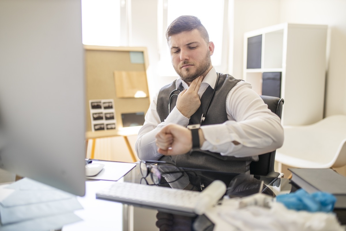 Doctor taking a pulse at office