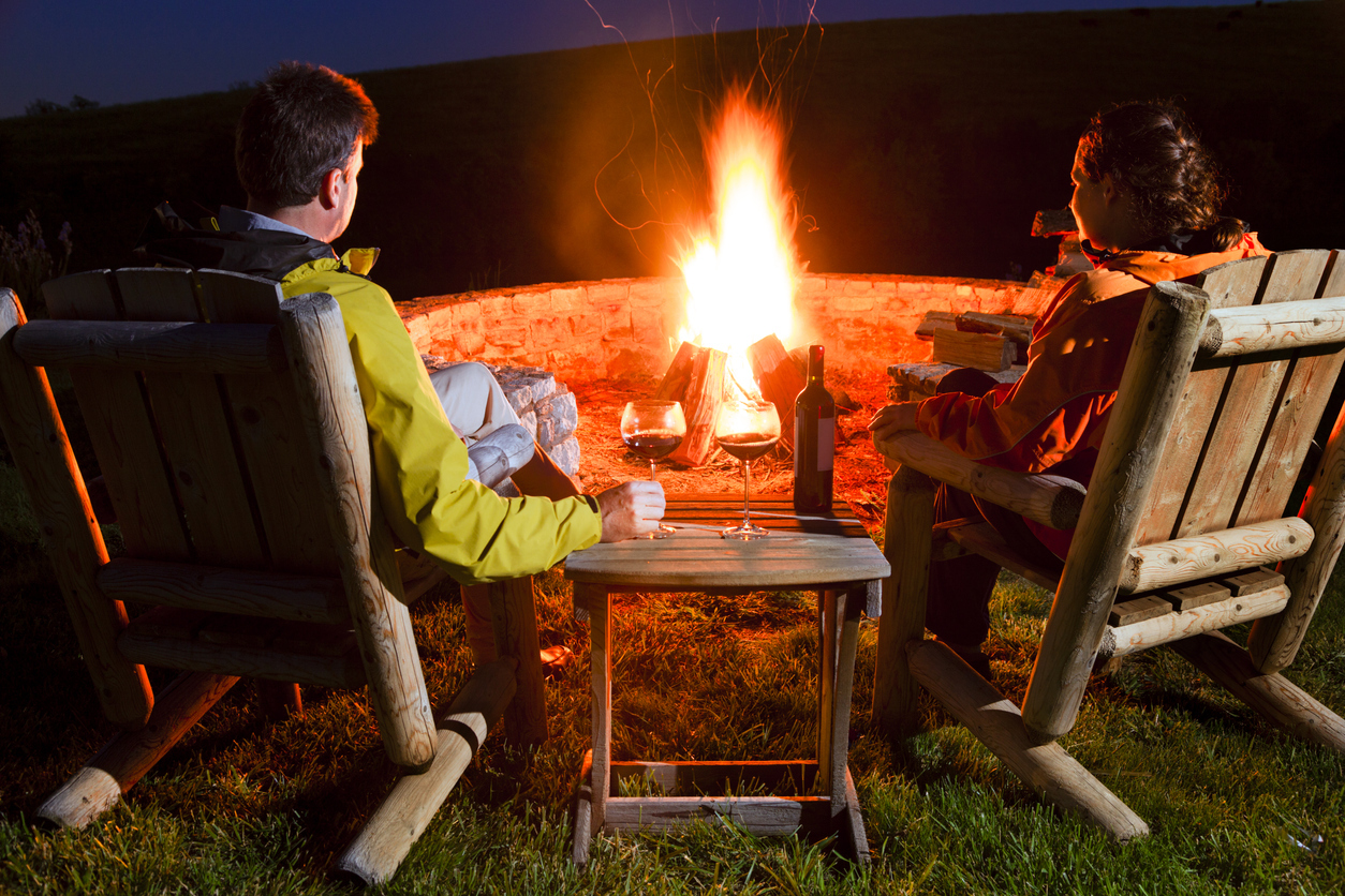 couple enjoying a bonfire outside at night