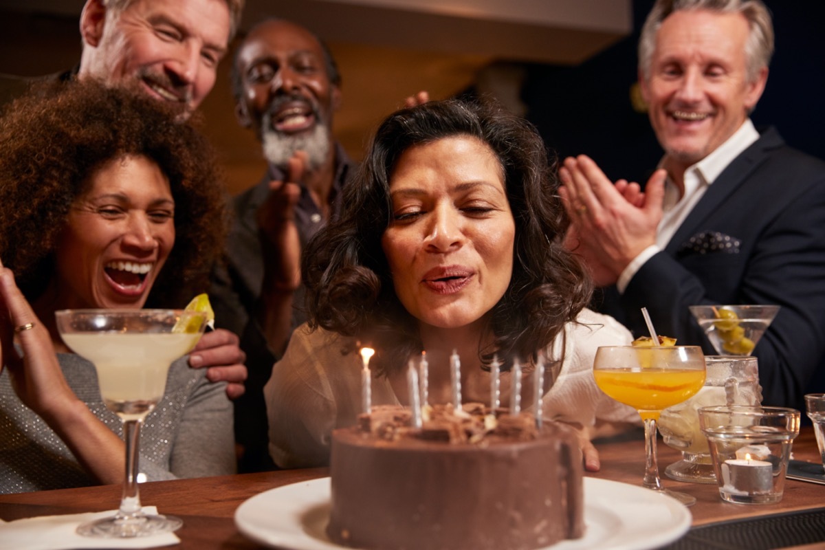 Group Of Middle Aged Friends Celebrating Birthday In Bar