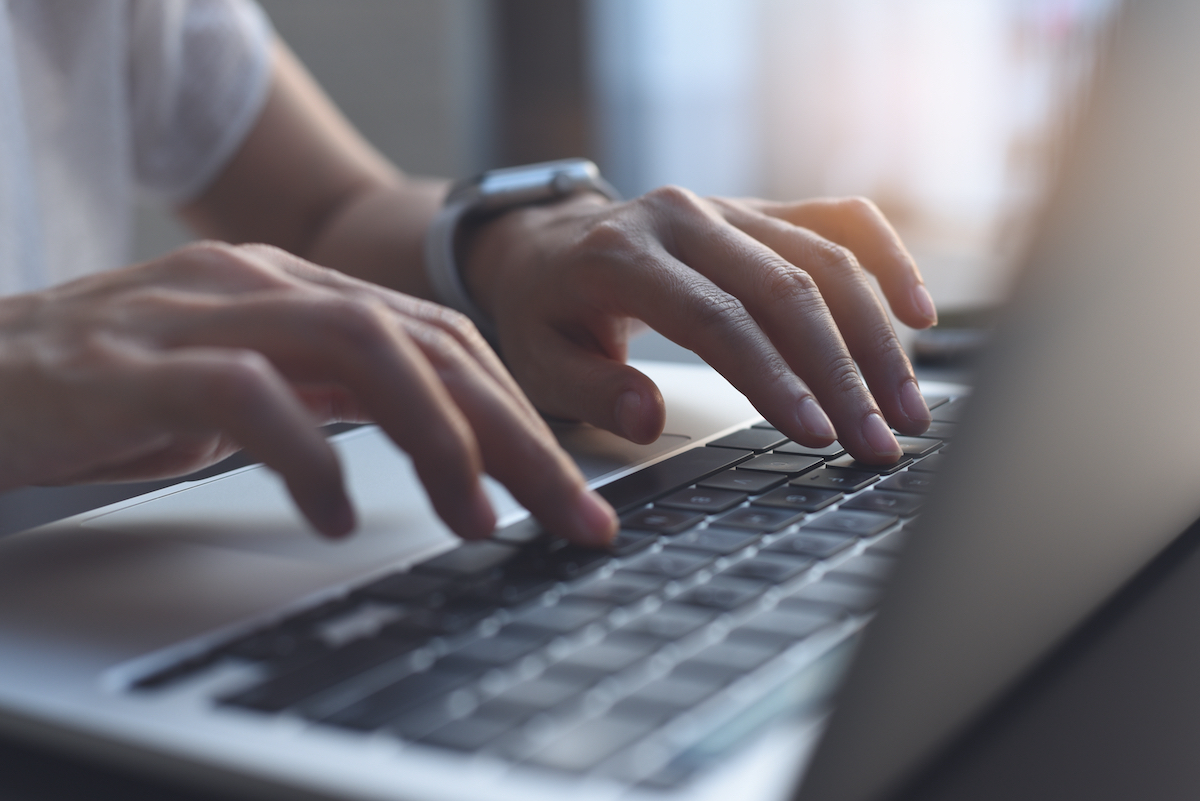 Woman Typing on Computer.