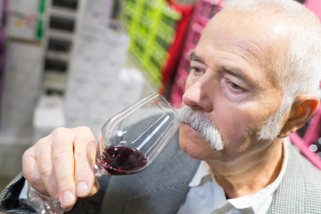 older man drinking wine