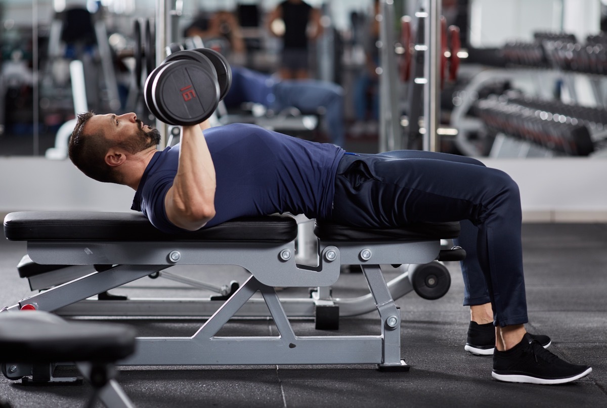 Man doing chest workout, bench press with dumbbells - Image