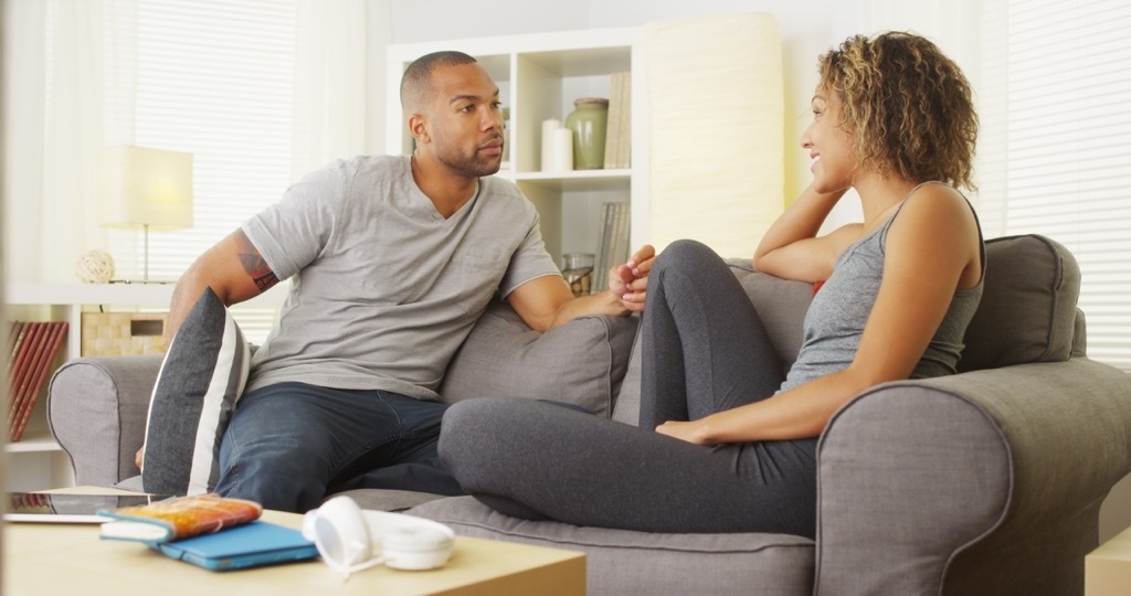 black couple talking on couch