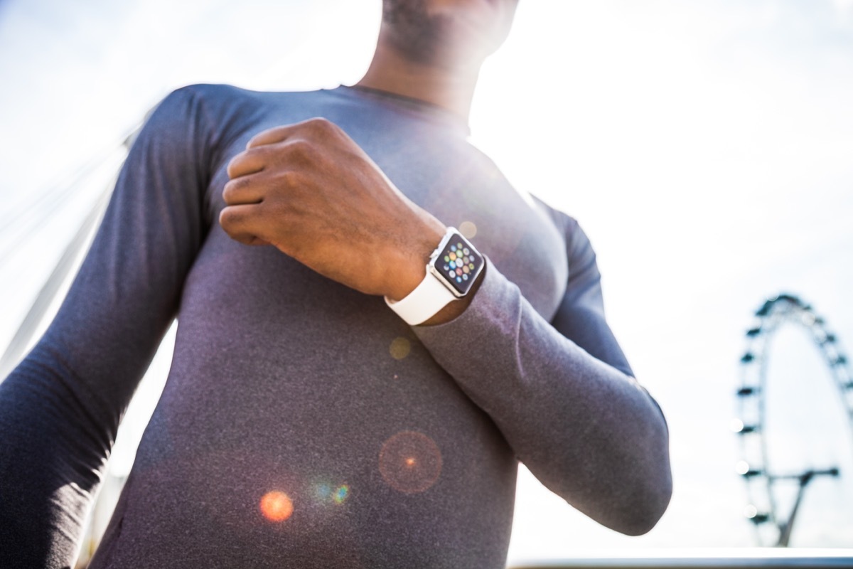 man wearing an apple watch on his wrist while working out