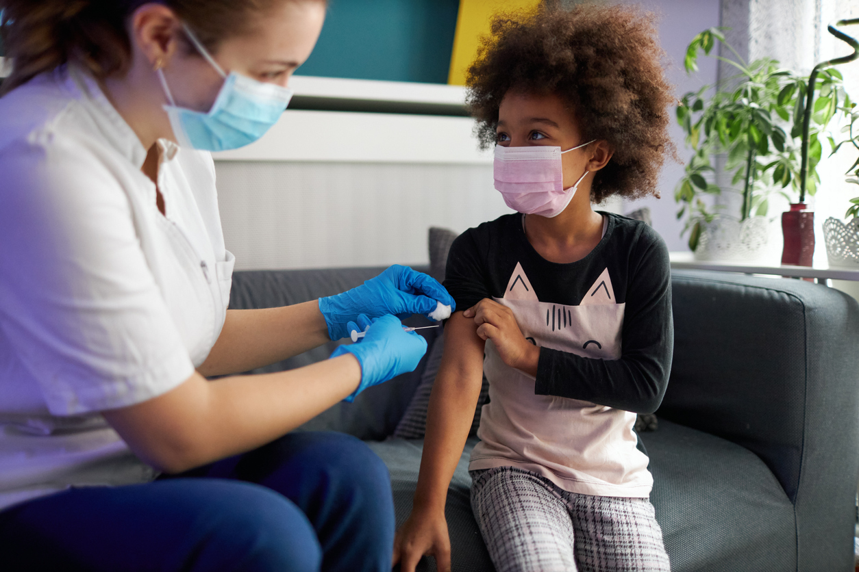 young girl getting vaccinated at home during pandemic times.