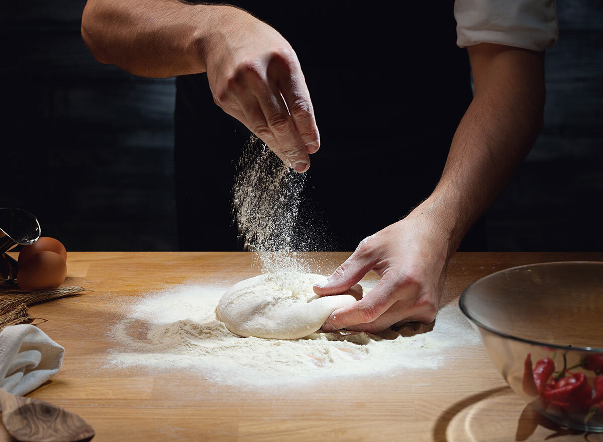 Adding flour on pizza dough