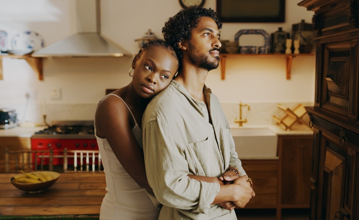 woman hugging partner in the kitchen