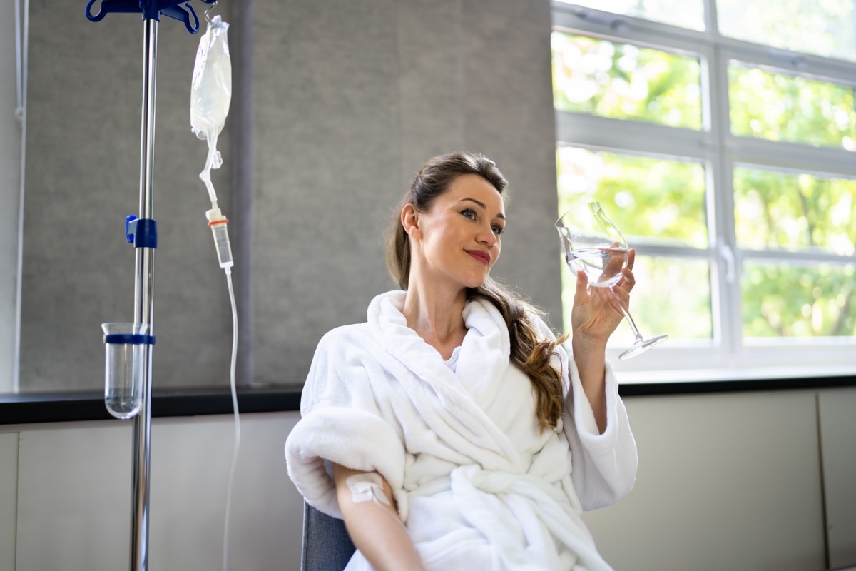 Woman receiving iv therapy for hangover. 