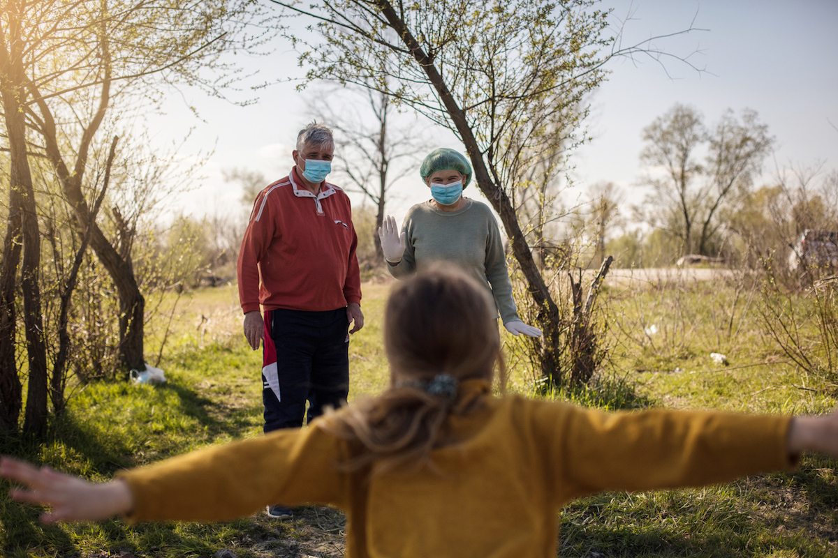 Granddaughter runs grandparents into a hug during the coronavirus pandemi