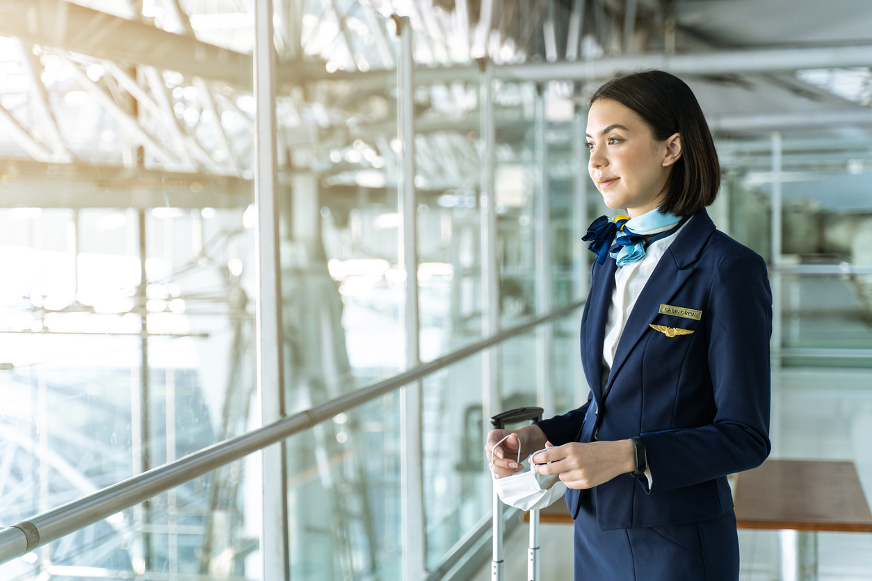 young flight attendant waiting for takeoff 