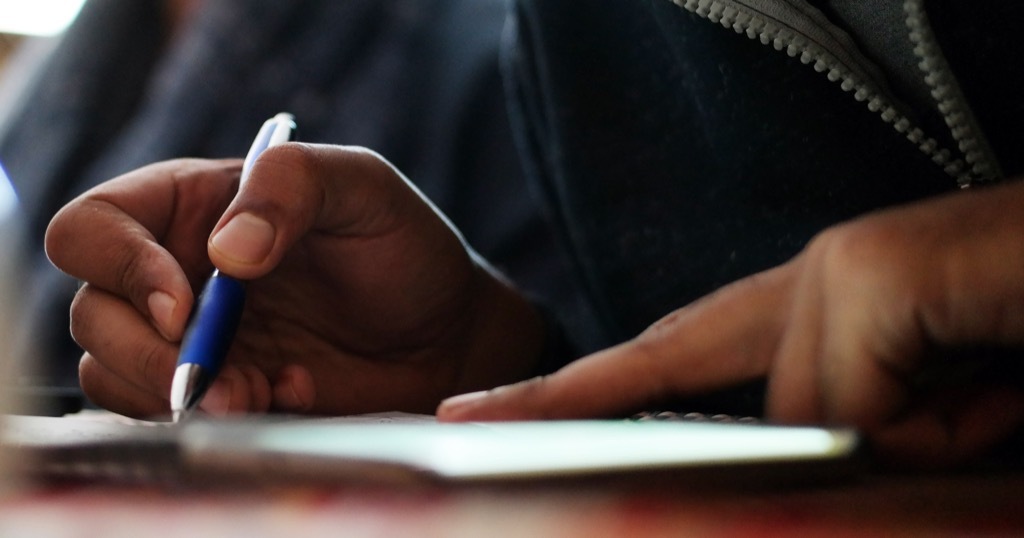 man signing papers