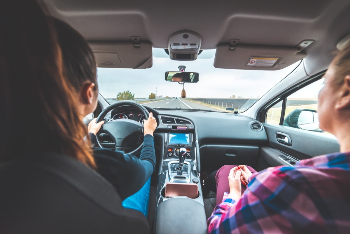 mom and daughter in car on drive