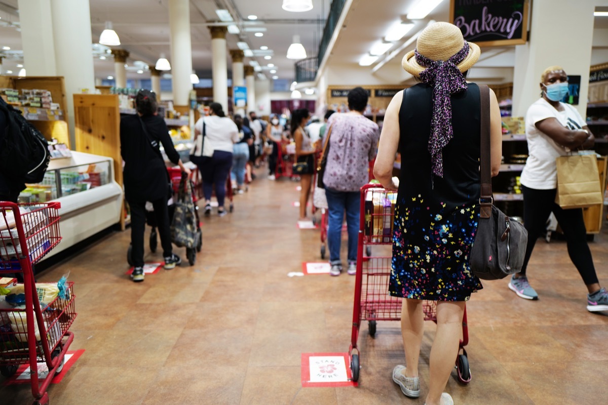 August 16, 2020 customer at Trader Joe's at Chelsea lining up with masks for the register, New York City, USA