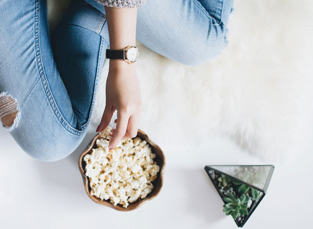 Woman eating popcorn