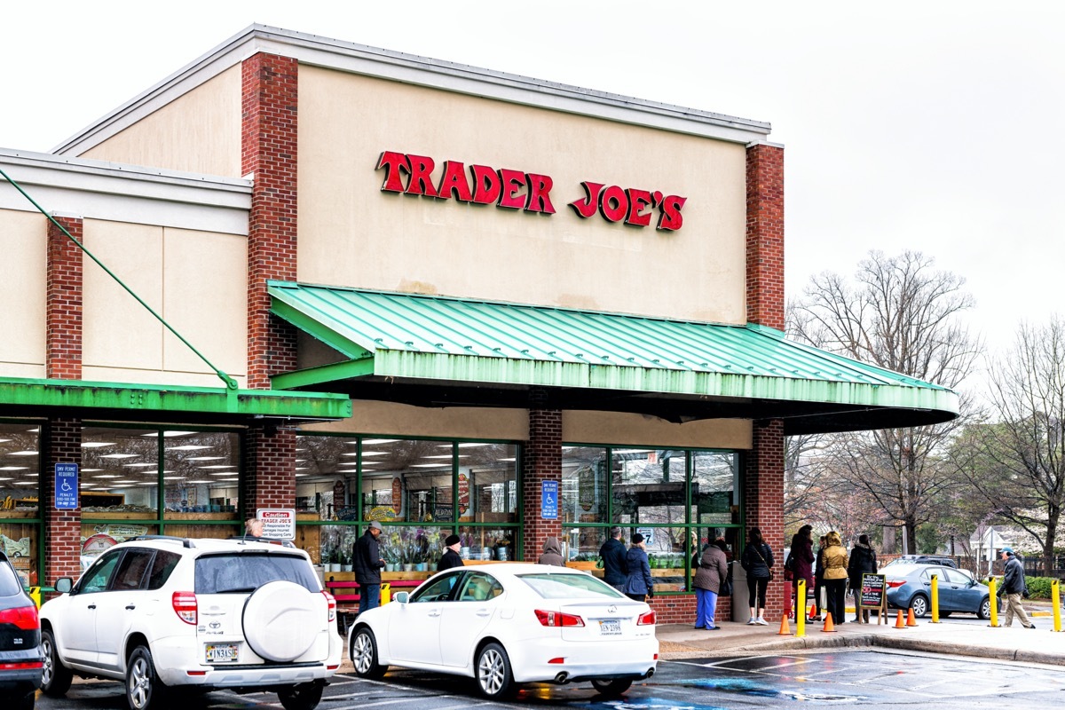 people lined up outside a trader joe's store