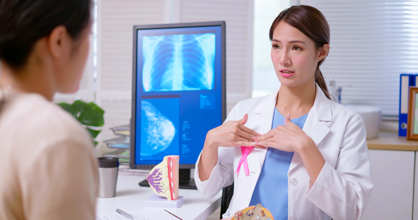 Doctor explaining breast self-examination to patient.