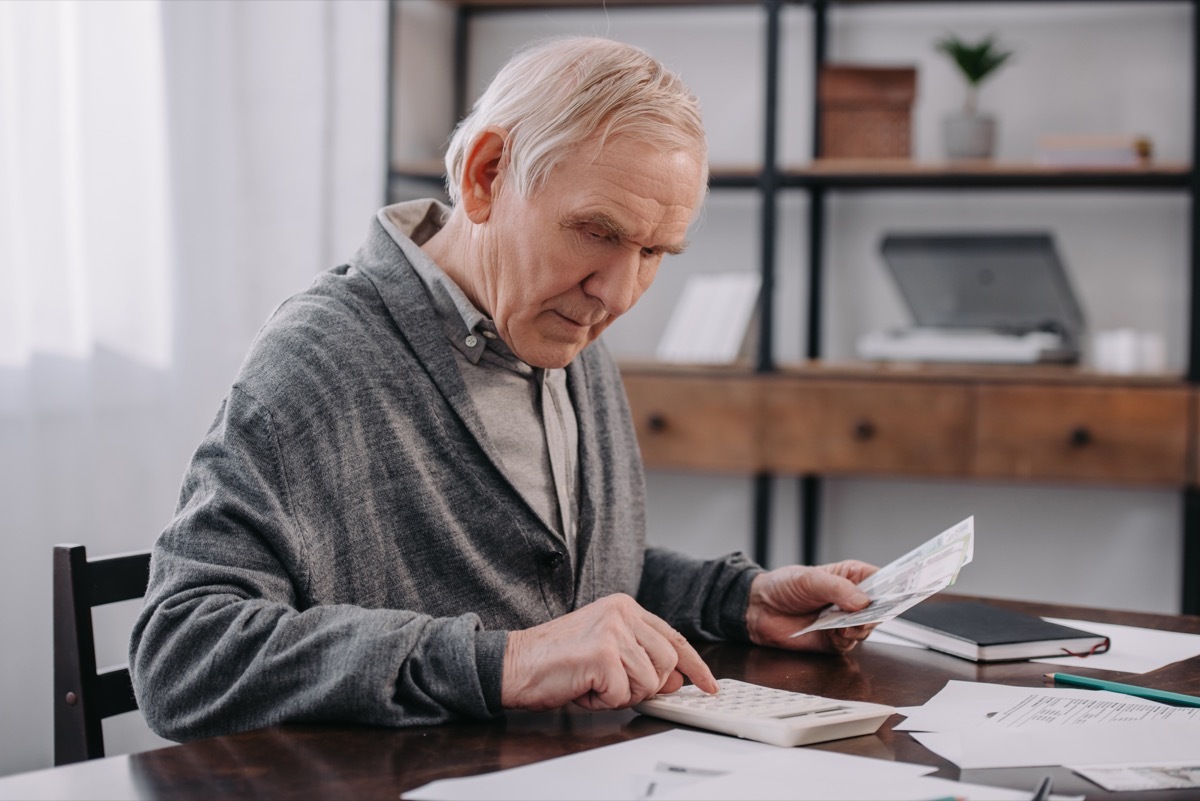 Older man calculating money