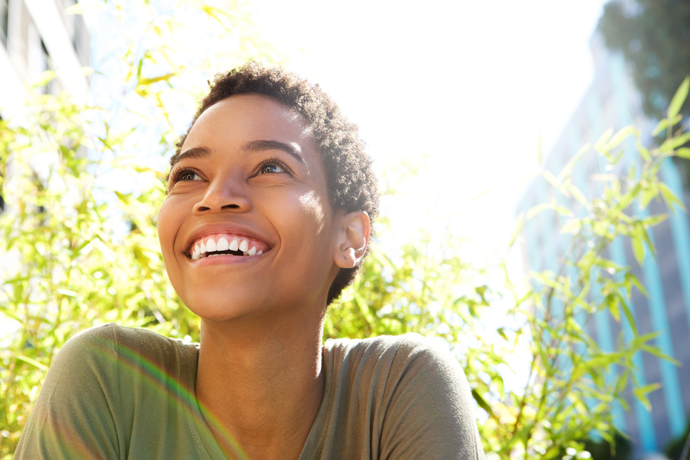 smiling woman with trees behind her