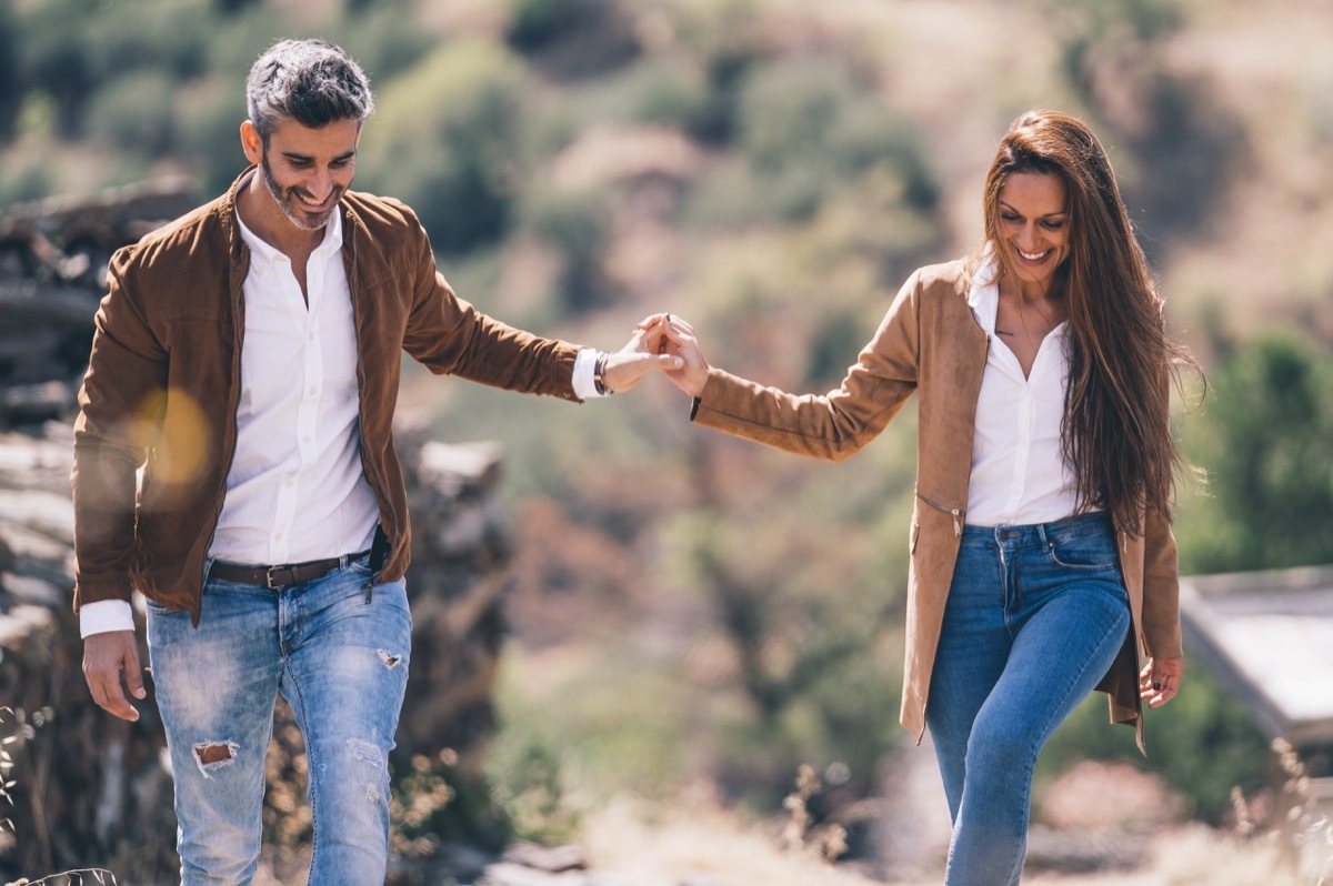 happy couple holding hands outside