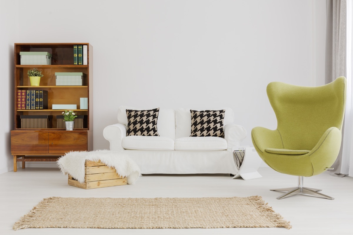 Harmonious and elegant living room decor, with a renovated modernist bookcase and a green egg chair