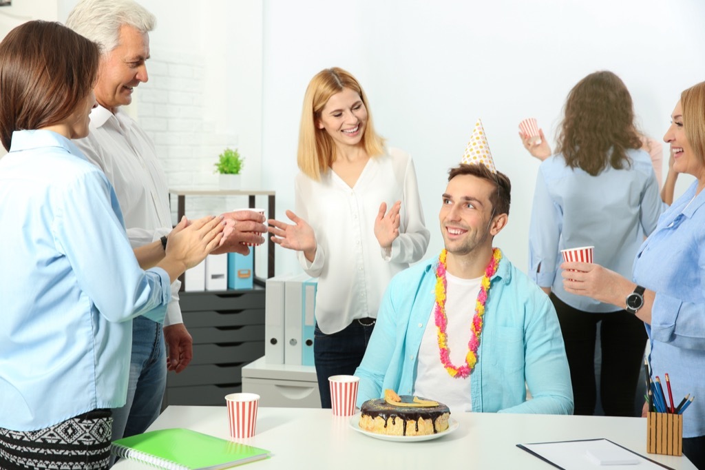 A man celebrating a birthday at work. 