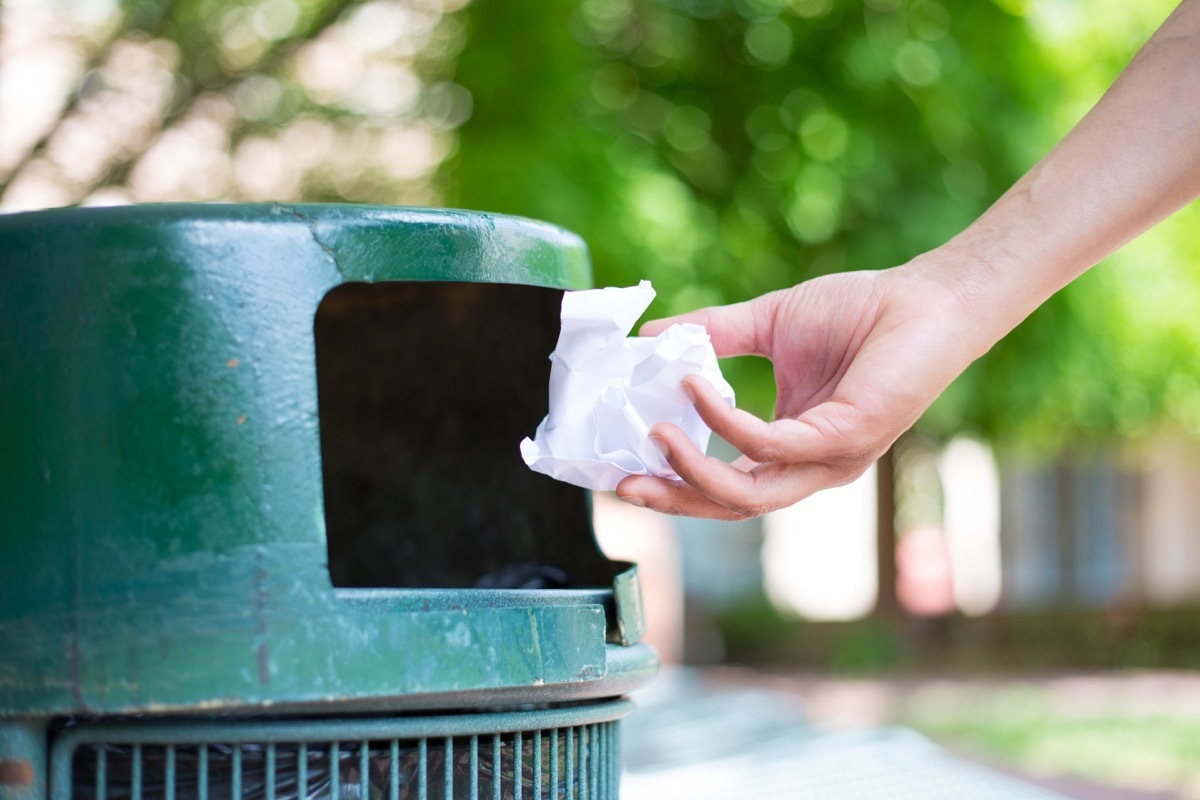 Person throwing away used tissue or paper