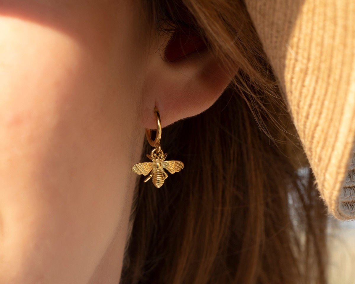 woman wearing gold bee earrings, Etsy jewelry