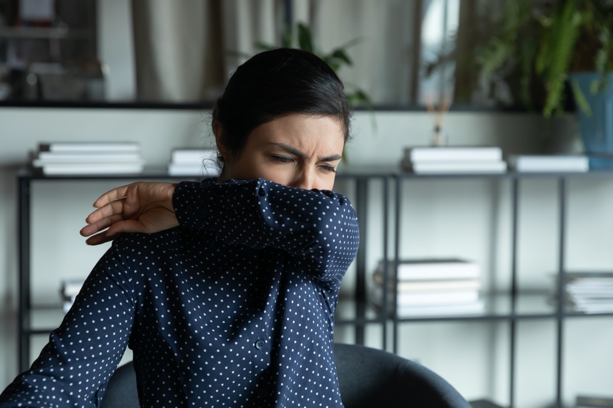 woman cough sneeze in elbow