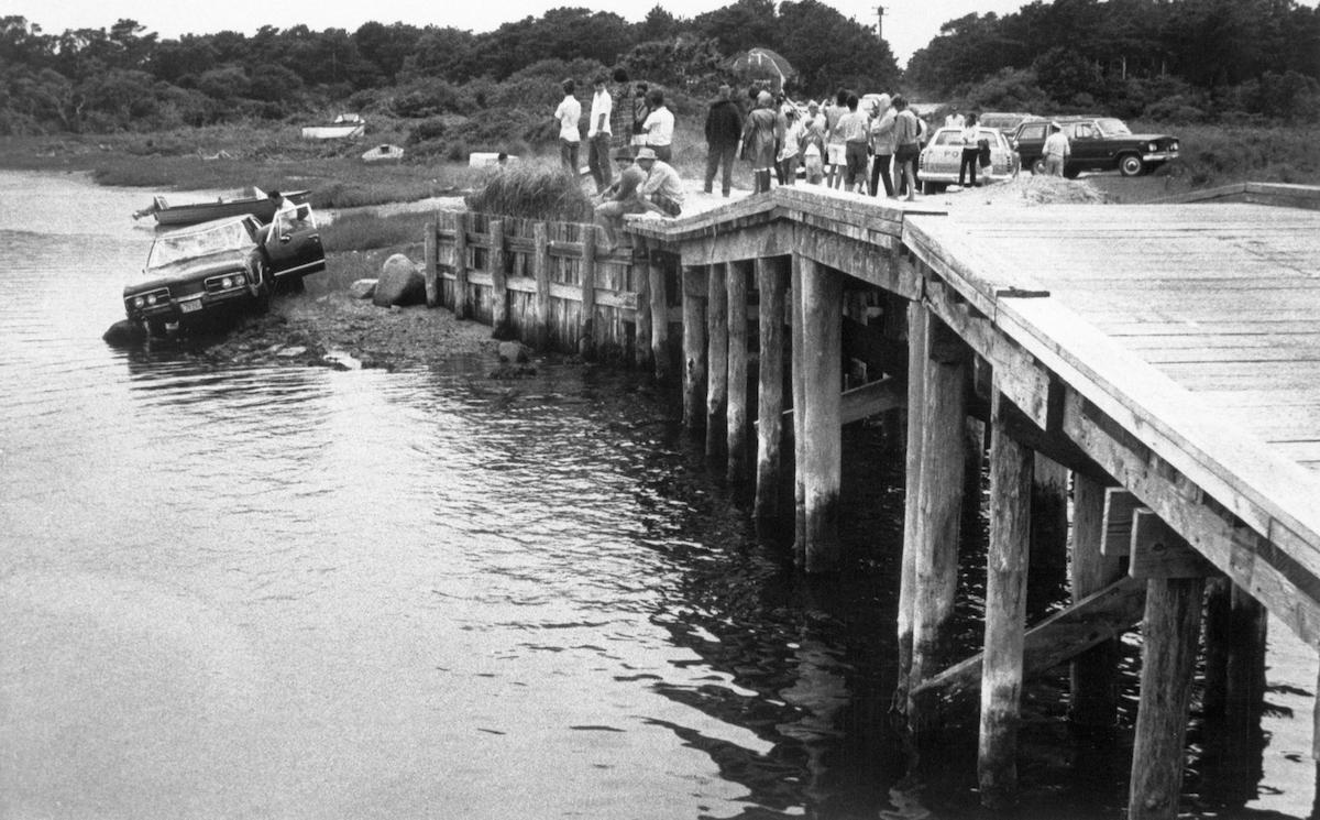 People look at Ted Kennedy's car following the incident