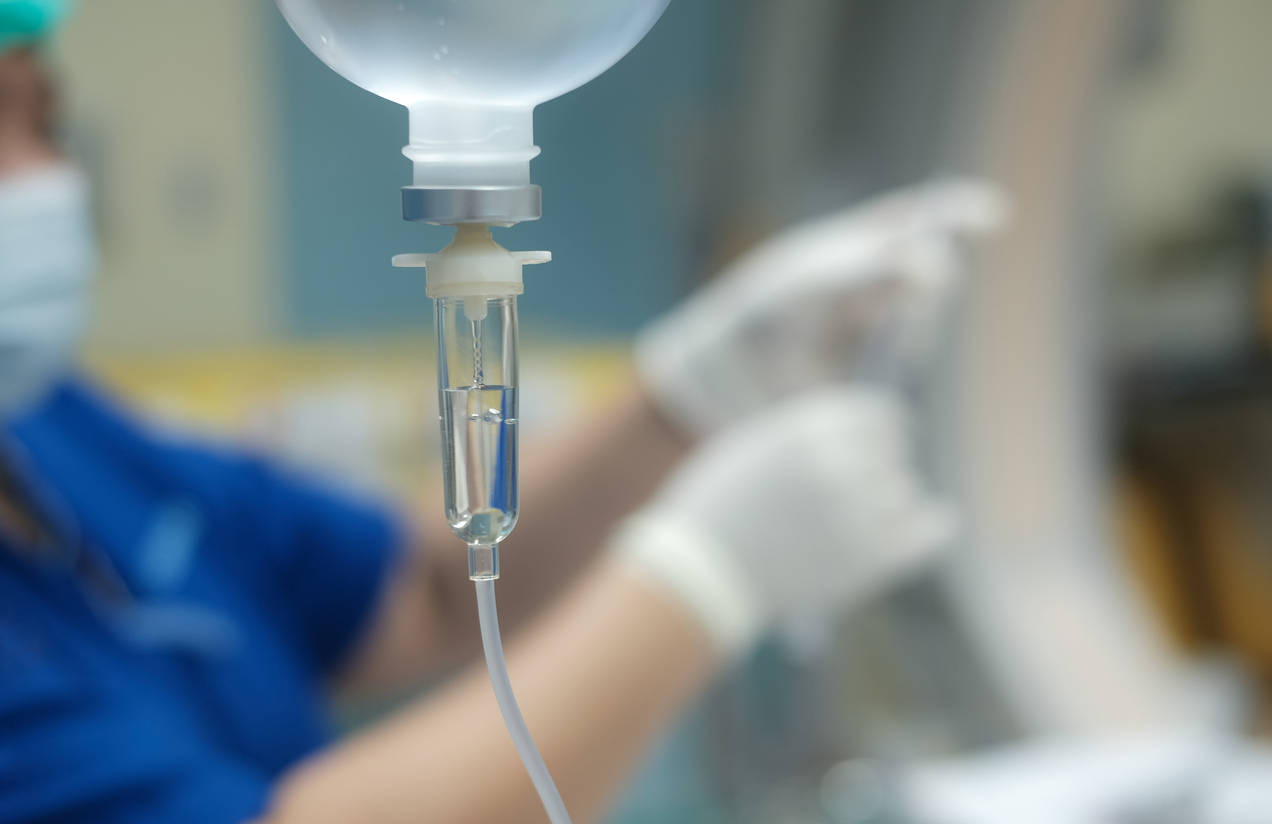 Intravenous medicine being administered in a hospital room. 