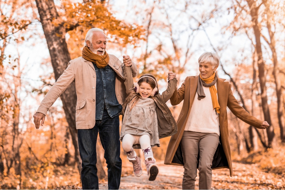 young older couple hanging out with grand daughter