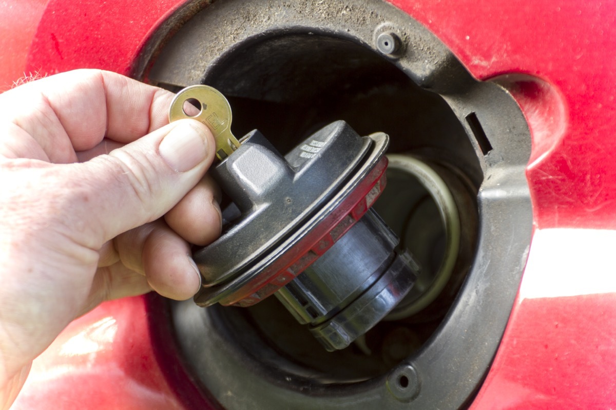 Removing a keyed locked gas cap from a truck.