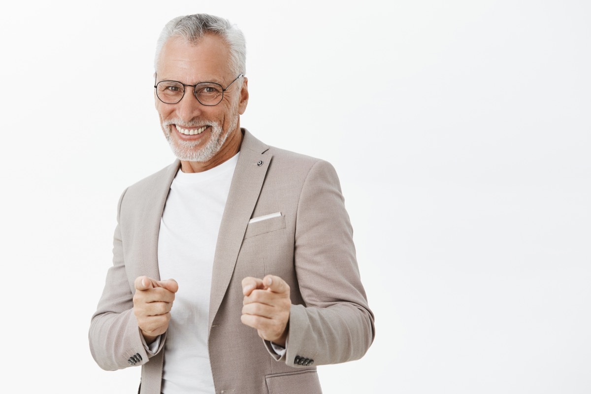 Older man doing finger guns