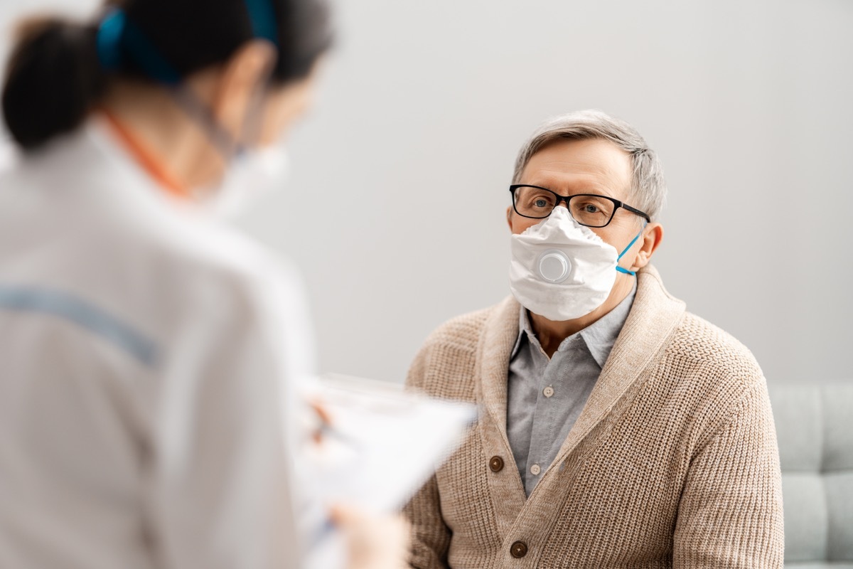 Doctor and senior man wearing facemasks