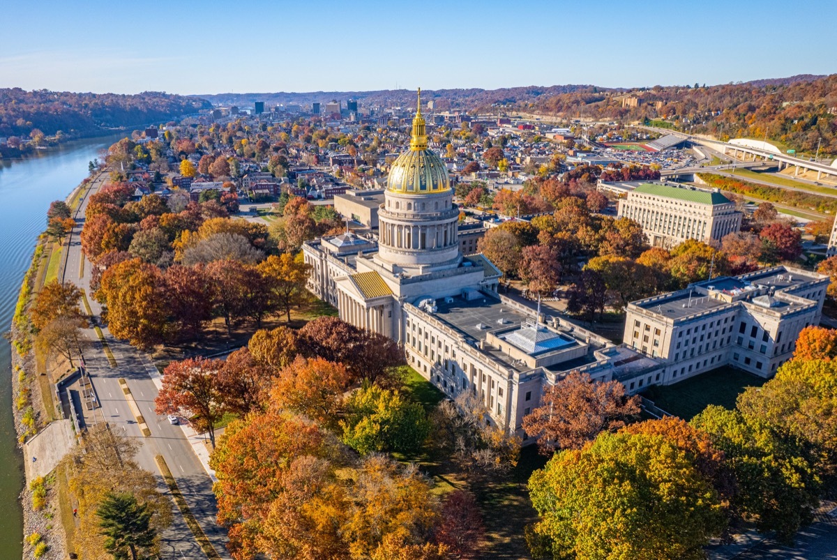 An aerial view of the West Virginia State Capitol Building and downtown Charleston with fall foliage