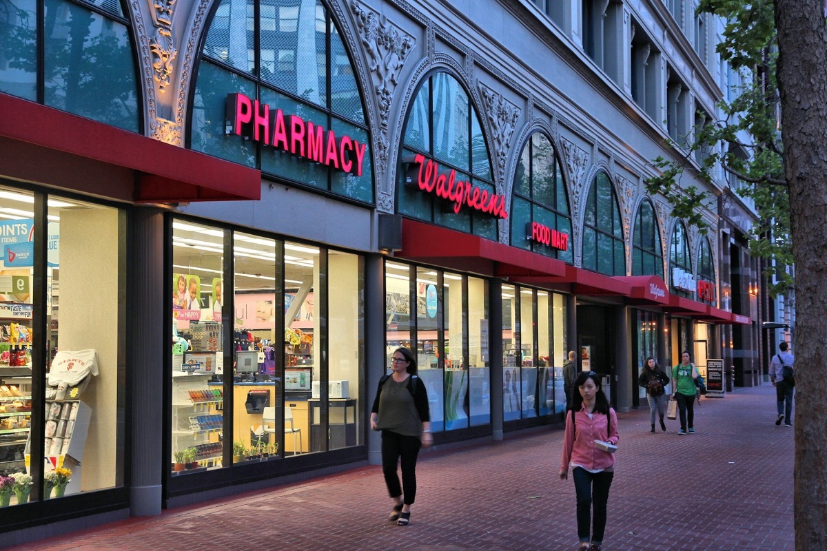 SAN FRANCISCO, USA - APRIL 8, 2014: People walk by Walgreens pharmacy and food mart in San Francisco, USA. Walgreen Co is the largest drugstore chain in the USA by sales.