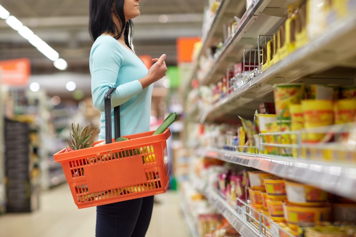 woman looking at grocery store shelves