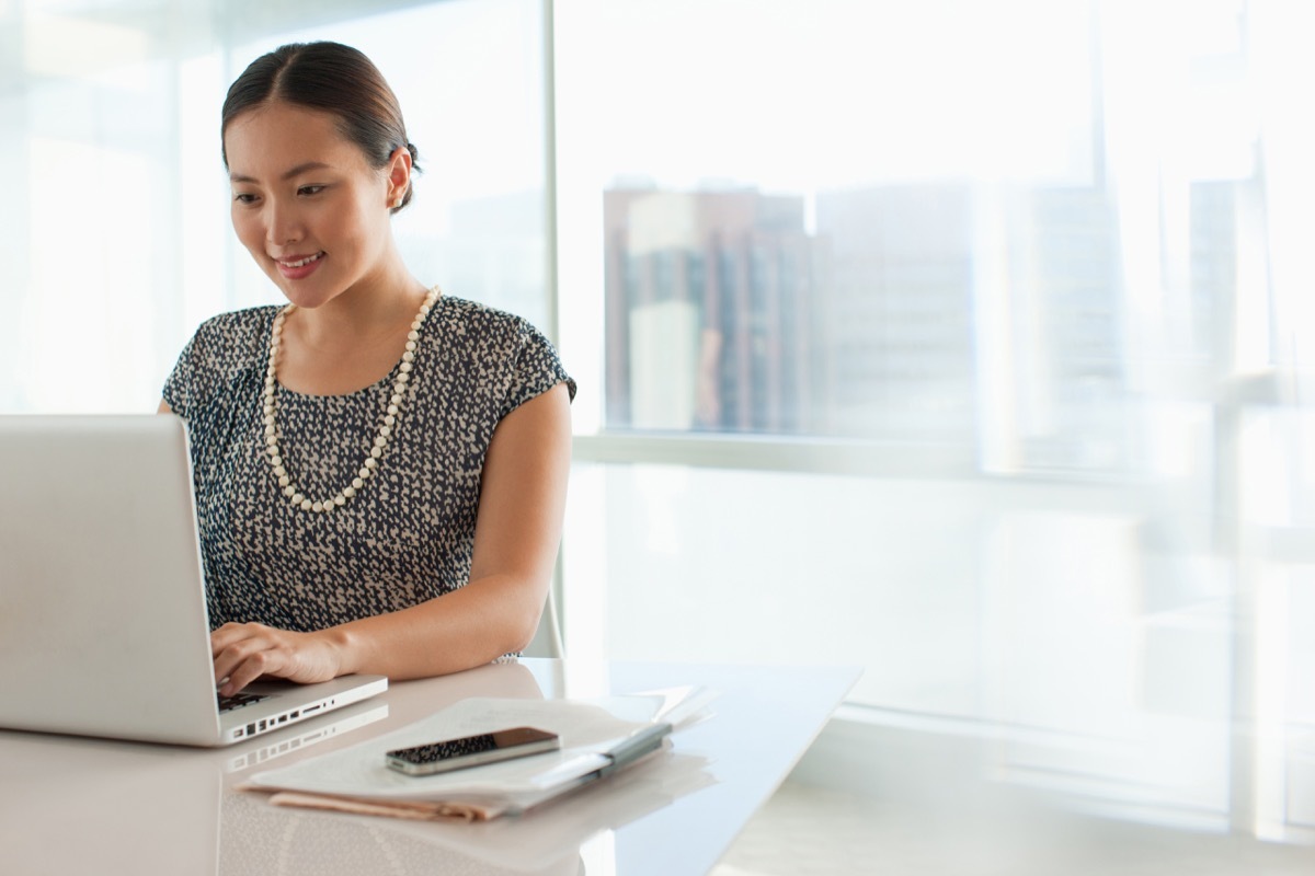 Businesswoman using laptop in office