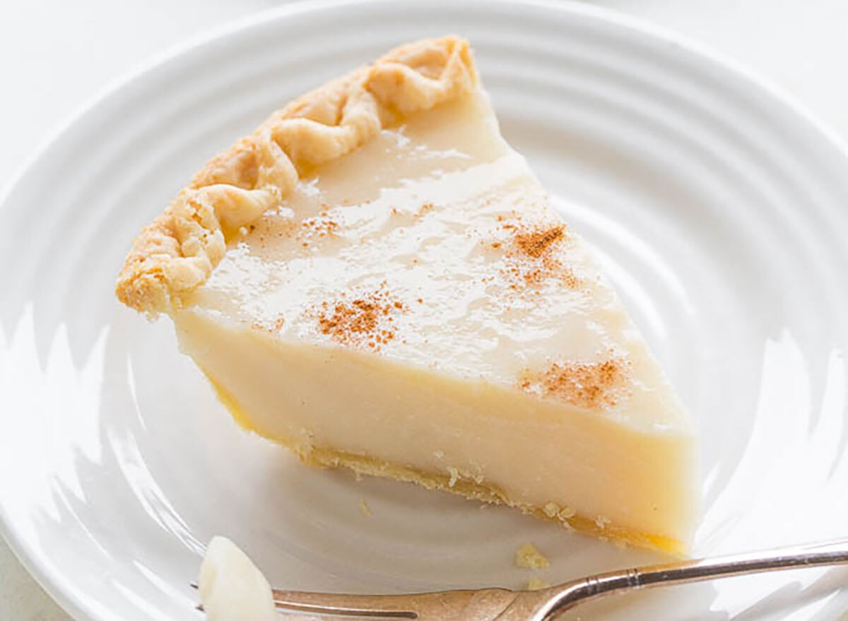 slice of sugar cream pie on white plate with fork