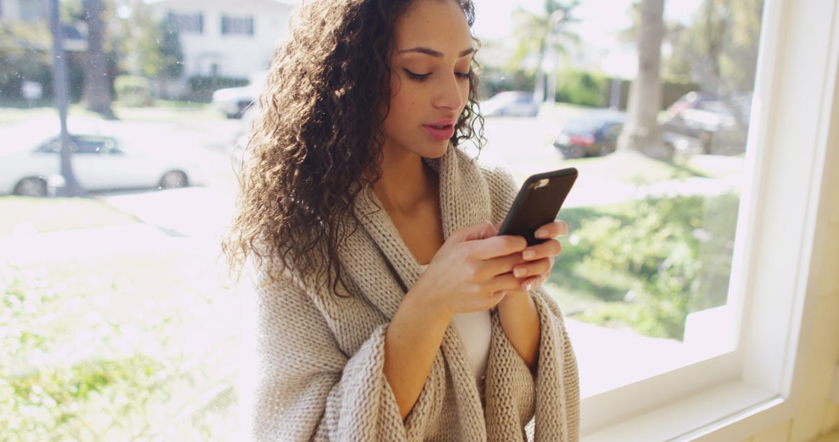 woman reading literotica on a smartphone