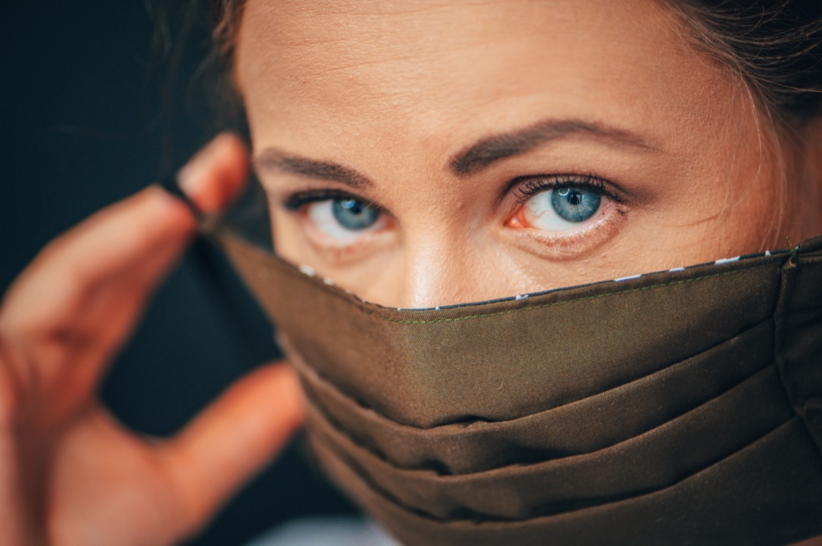 woman wearing home made hygienic face medical mask to prevent infection,