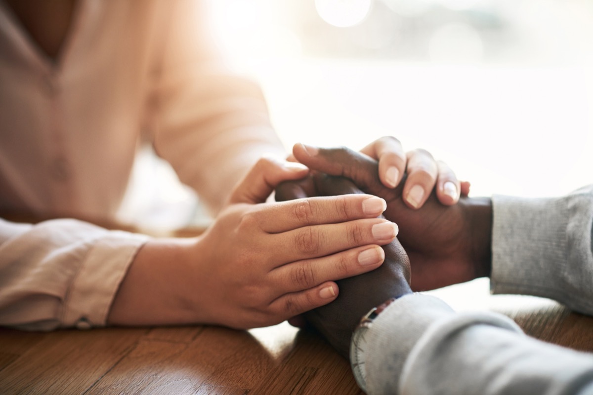 Closeup shot of two unrecognizable people holding hands in comfort