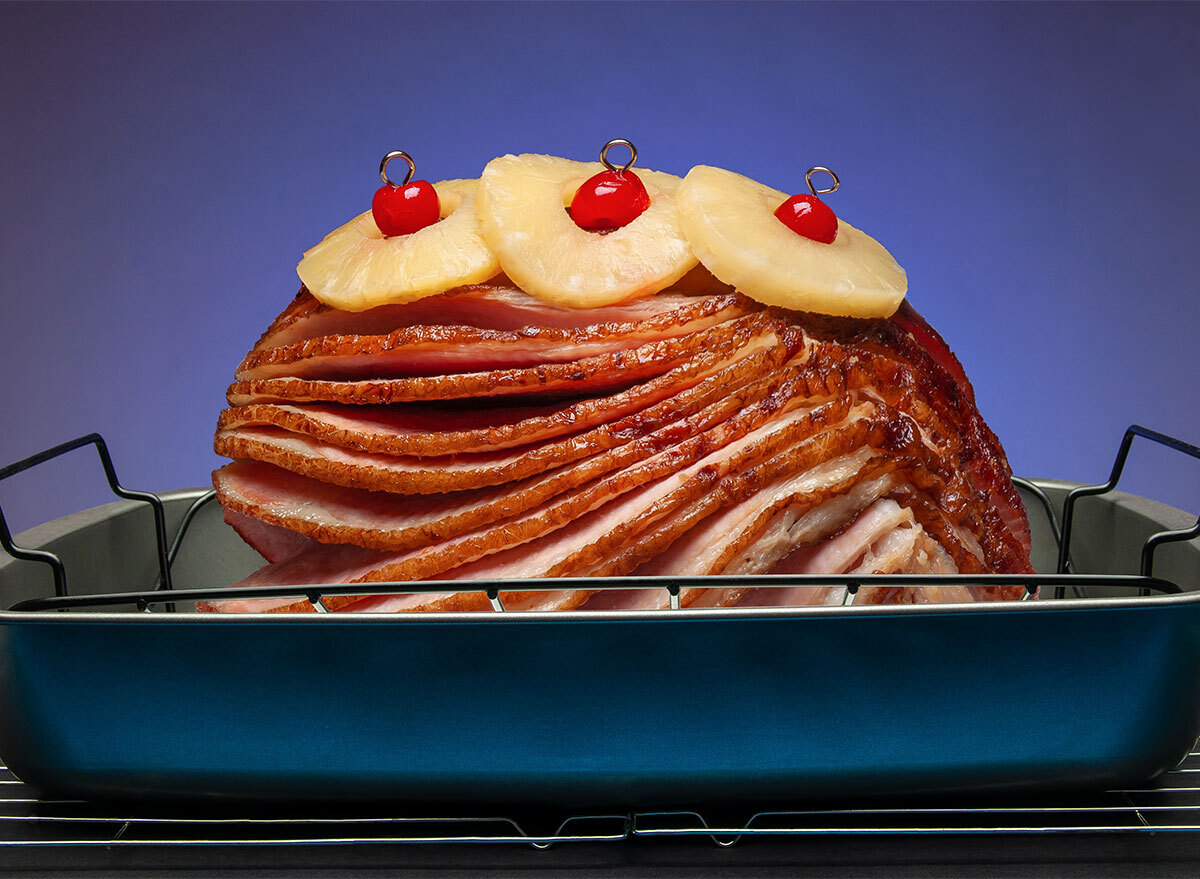 spiral ham in baking dish with pineapple slices