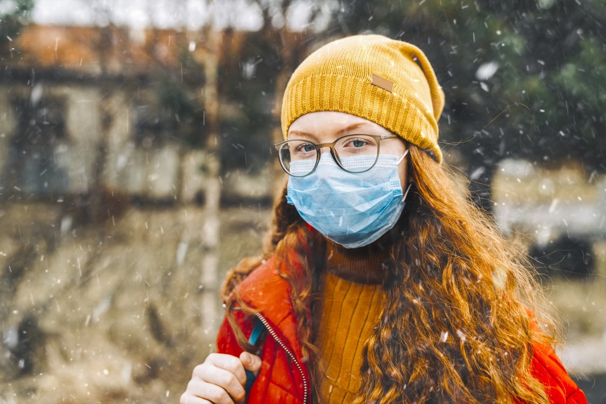 Teenage girl wearing protective mask for school during medical crisis of epidemic virus spreading covid 19