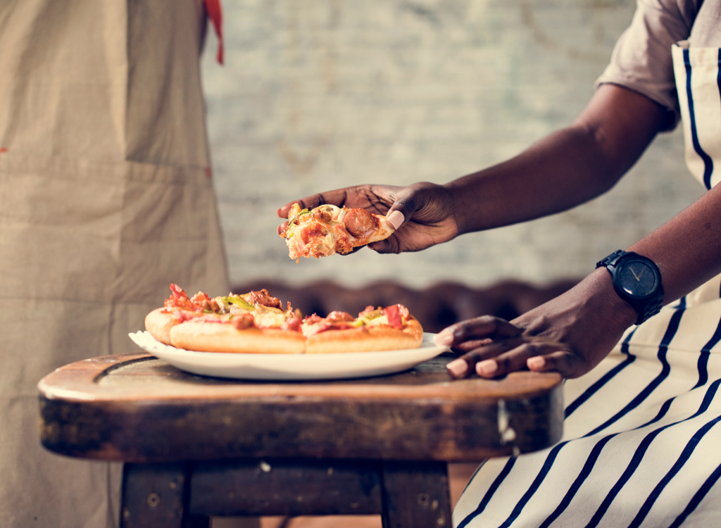 Man reaching for pizza