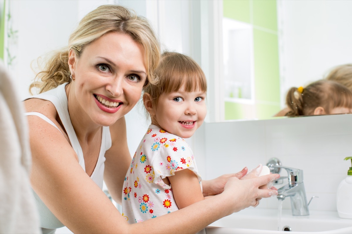 mother washing baby hands